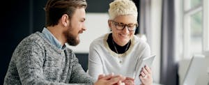 Hip woman explaining credit counseling to a young man