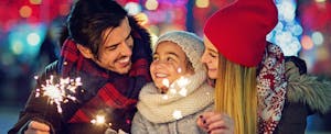 Family with sparklers enjoying holiday travel