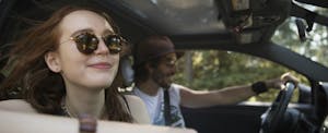 insurance-scores-affect-car-insurance-rates A couple drive a car after learning how insurance scores affect car insurance rates