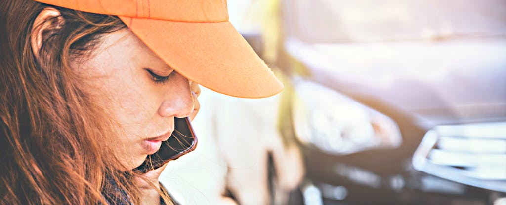 A young woman calls a friend to see if car repossession can hurt credit.