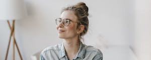 Smiling young woman resolved to pay off debt