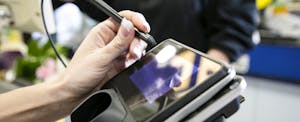 Woman signing payment terminal Woman signing payment terminal