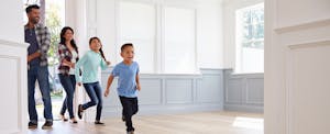 Young family looking a new house that they got after learning the 5 cs of credit