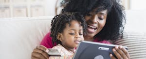 Mother and daughter shopping on tablet computer