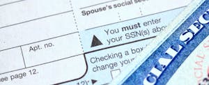 irs-new-tax-transcript Close shot of the Social Security number field of a 1040 tax form, and the corner of a Social Security card.