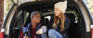 how-much-car-afford Couple in the open back of car looking at each other