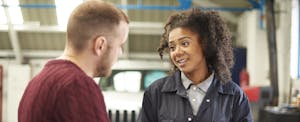 Mechanic explaining the cost of a car repair to car owner