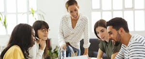 A group of coworkers sitting at a table and having a conversation