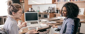 Two coworkers talking to each other