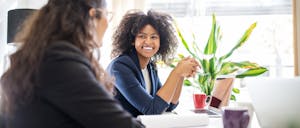 women-believe-equal-pay-will-happen-in-lifetime-survey Woman in meeting with coworker at start up office