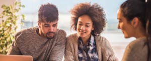 Couple sitting in a bank to open a joint checking account