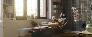 Man in living room sitting in chair relaxing