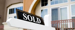 "Sold" sign in front of a recently purchased home