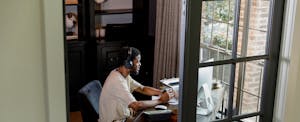 Man sitting at his desk in his home office, working on his computer