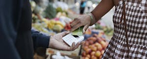 Woman pays for groceries with her credit card.